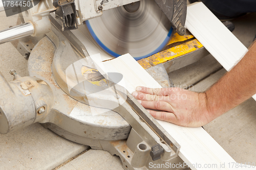 Image of Contractor Cutting New Baseboard for Renovation