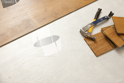 Image of Hammer and Pry Bar with Laminate Flooring Abstract