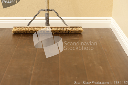 Image of Push Broom on a Newly Installed Laminate Floor and Baseboard