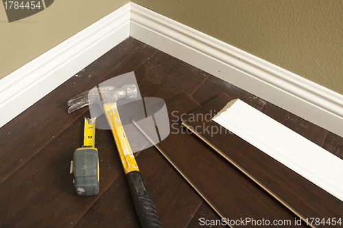 Image of Hammer, Laminate Flooring and New Baseboard Molding