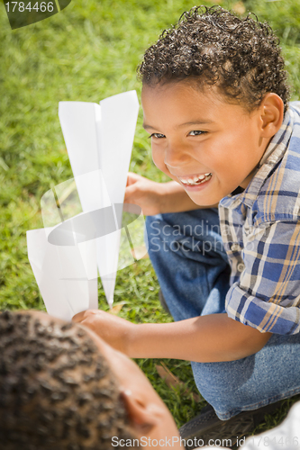 Image of Mixed Race Father and Son Playing with Paper Airplanes