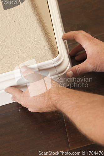 Image of Contractor Installing New Baseboard with Bull Nose Corners and N