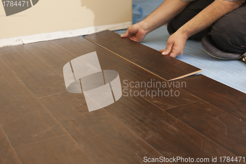 Image of Man Installing New Laminate Wood Flooring