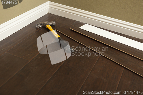 Image of Hammer, Laminate Flooring and New Baseboard Molding