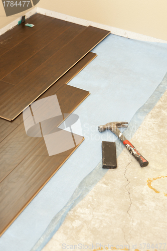 Image of Hammer and Block with New Laminate Flooring