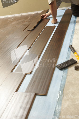 Image of Man Installing New Laminate Wood Flooring