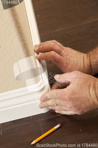 Image of Contractor Installing New Baseboard with Bull Nose Corners and N