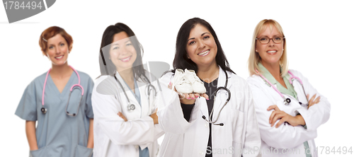 Image of Hispanic Female Doctor or Nurse with Baby Shoes and Support Staf