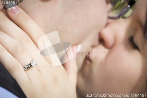Image of Female Hand with Engagement Ring Touching Fiance's Face