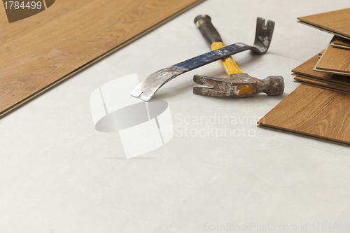 Image of Hammer and Pry Bar with Laminate Flooring Abstract