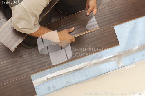 Image of Man Installing New Laminate Wood Flooring