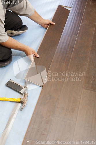 Image of Man Installing New Laminate Wood Flooring