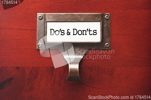 Image of Lustrous Wooden Cabinet with Do's and Don'ts File Label