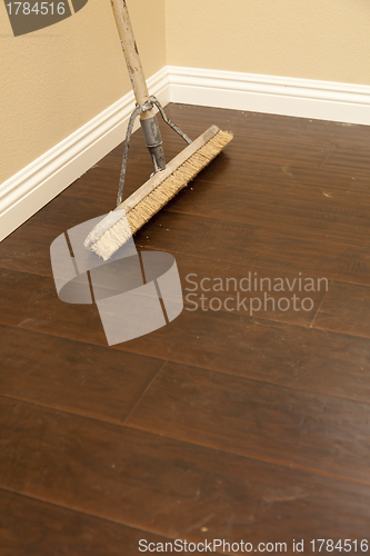 Image of Push Broom on a Newly Installed Laminate Floor and Baseboard