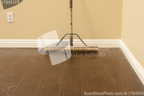 Image of Push Broom on a Newly Installed Laminate Floor and Baseboard