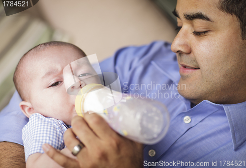 Image of Happy Hispanic Father Bottle Feeding His Son