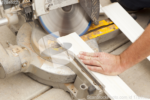 Image of Contractor Cutting New Baseboard for Renovation