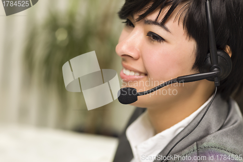 Image of Attractive Young Mixed Race Woman Smiles Wearing Headset