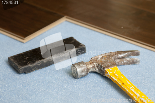 Image of Hammer and Block with New Laminate Flooring