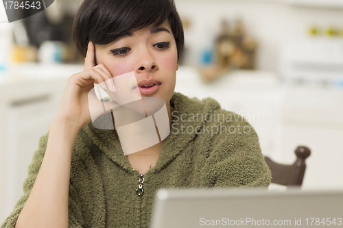 Image of Pretty Mixed Race Woman Using Laptop at Home