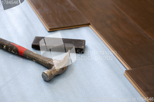 Image of Hammer and Block with New Laminate Flooring