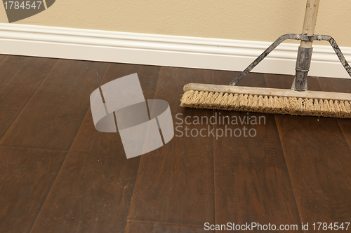 Image of Push Broom on a Newly Installed Laminate Floor and Baseboard