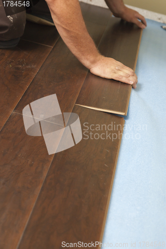 Image of Man Installing New Laminate Wood Flooring