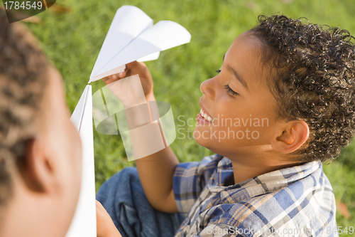 Image of Mixed Race Father and Son Playing with Paper Airplanes