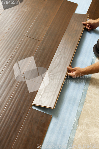 Image of Man Installing New Laminate Wood Flooring