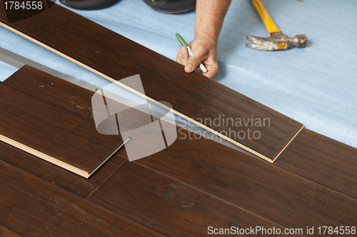 Image of Man Installing New Laminate Wood Flooring