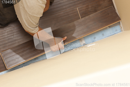 Image of Man Installing New Laminate Wood Flooring