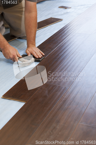 Image of Man Installing New Laminate Wood Flooring