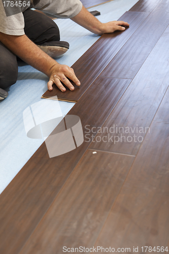 Image of Man Installing New Laminate Wood Flooring