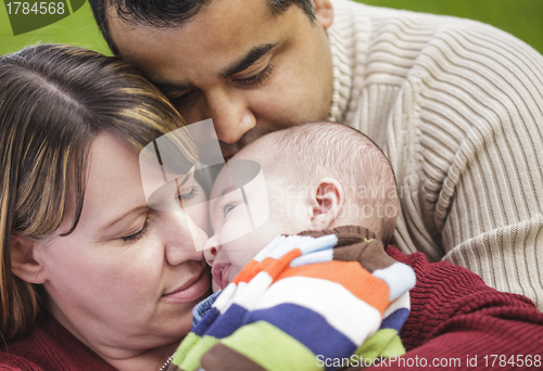 Image of Happy Mixed Race Parents Hugging Their Son