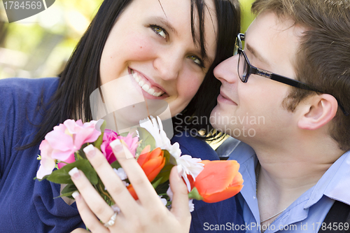 Image of Attractive Young Man Gives Flowers to His Love