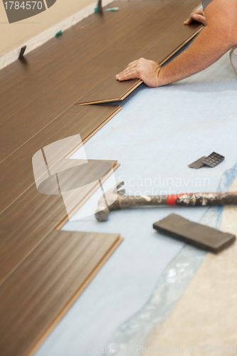 Image of Man Installing New Laminate Wood Flooring