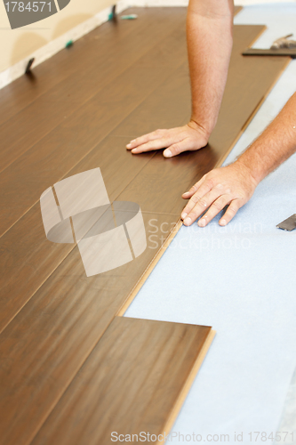 Image of Man Installing New Laminate Wood Flooring