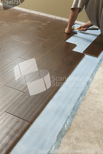 Image of Man Installing New Laminate Wood Flooring