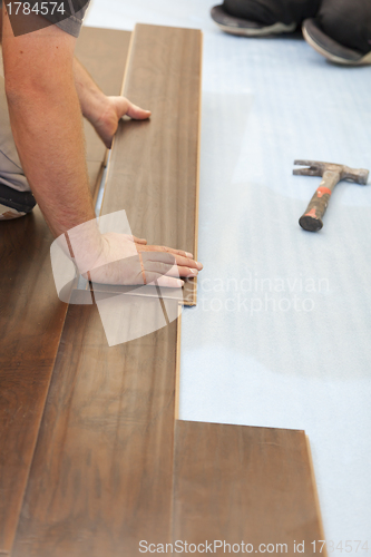 Image of Man Installing New Laminate Wood Flooring