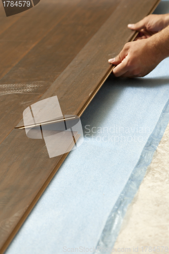 Image of Man Installing New Laminate Wood Flooring