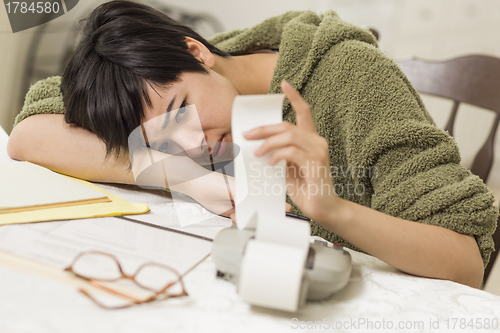 Image of Mixed Race Young Female Agonizing Over Financial Calculations