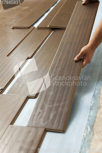 Image of Man Installing New Laminate Wood Flooring