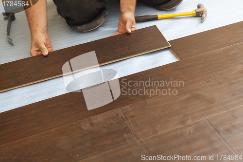 Image of Man Installing New Laminate Wood Flooring