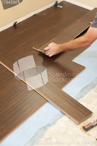 Image of Man Installing New Laminate Wood Flooring