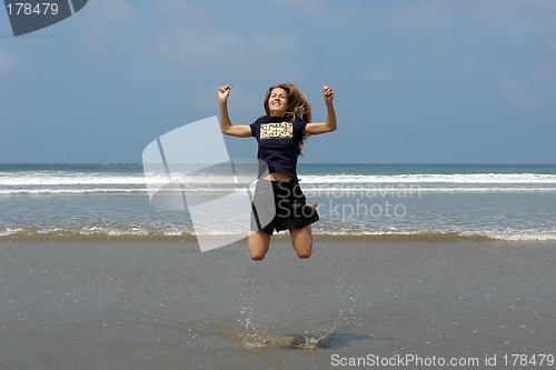 Image of jumping girl on the beach