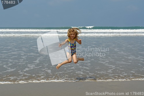 Image of jumping child on the beach