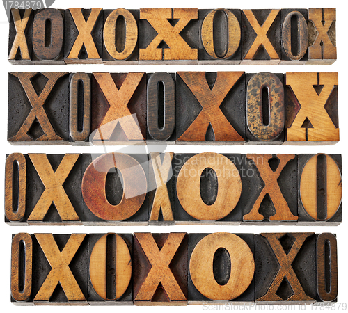 Image of letters O and X in wood type