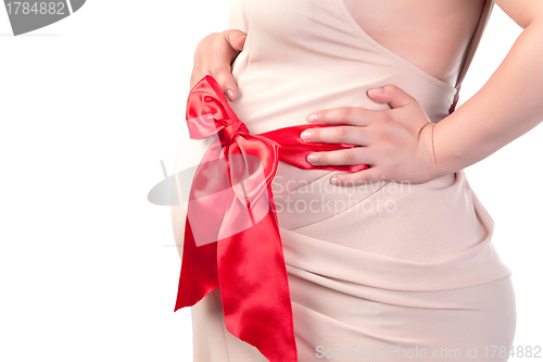 Image of Pregnant Woman's Belly with Red Ribbon