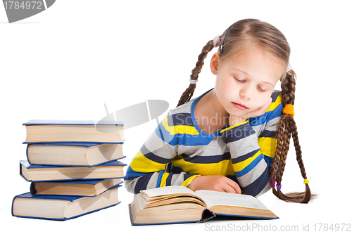 Image of schoolgirl  sleeping over the book on isolated white