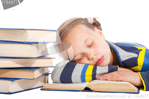 Image of schoolgirl  sleeping over the book on isolated white